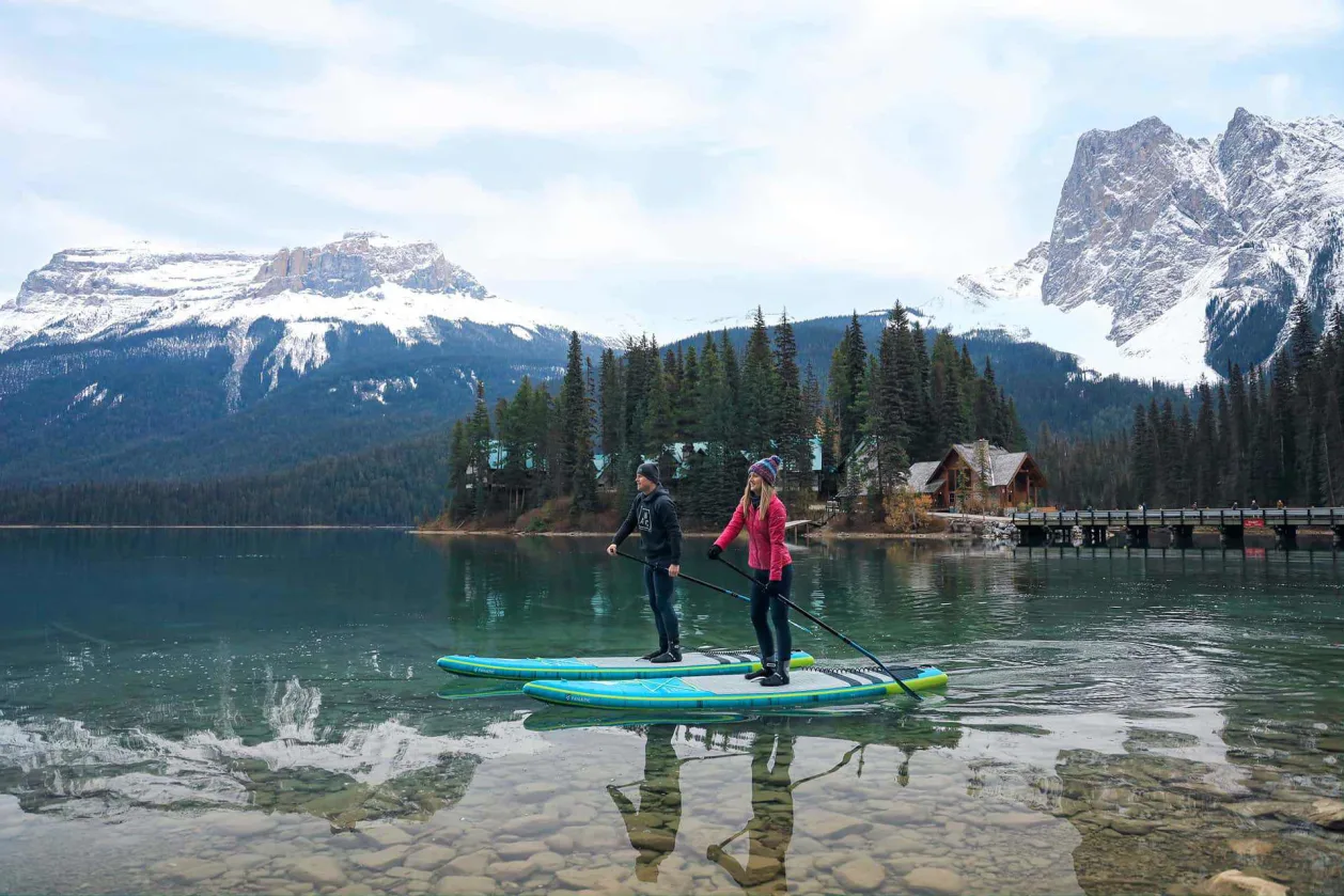 Emerald Lake Lodge couple on SUPs and paddleboard